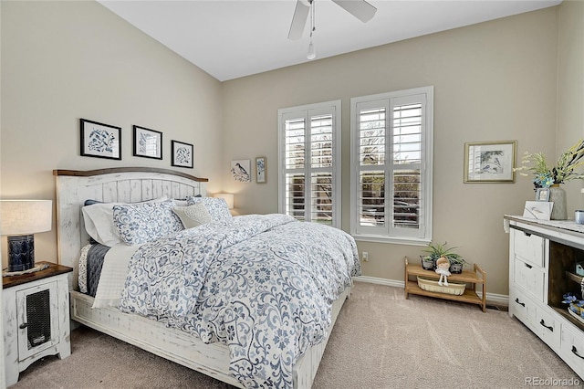 carpeted bedroom featuring baseboards and a ceiling fan