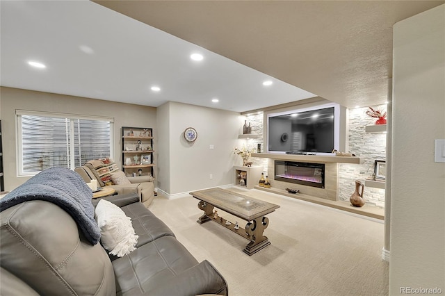 living room featuring a glass covered fireplace, baseboards, carpet flooring, and recessed lighting