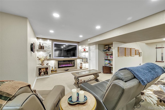 living area featuring carpet flooring, recessed lighting, and a glass covered fireplace