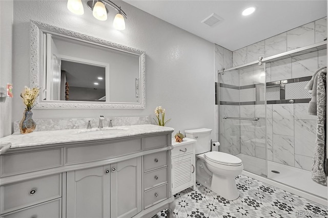 bathroom with visible vents, vanity, toilet, recessed lighting, and a shower stall
