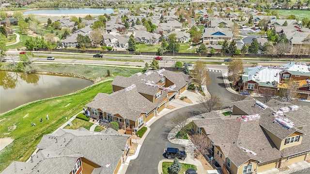 bird's eye view with a water view and a residential view