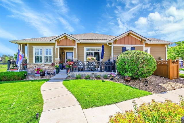 3751 W 136th Ave Unit F4, Broomfield, CO 80023 - view of front of property with board and batten siding, covered porch, a front lawn, and stone siding
