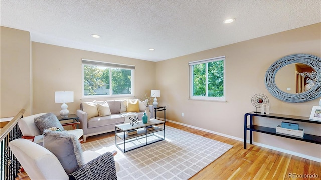 6631 Welch Ct, Arvada, CO 80004 - living area featuring plenty of natural light, wood finished floors, a textured ceiling, baseboards, and recessed lighting