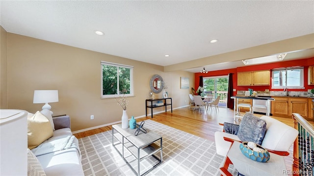 6631 Welch Ct, Arvada, CO 80004 - living room featuring light wood-type flooring, baseboards, and recessed lighting