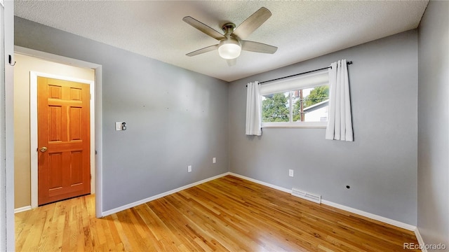 6631 Welch Ct, Arvada, CO 80004 - unfurnished room with light wood-style flooring, baseboards, ceiling fan, and a textured ceiling