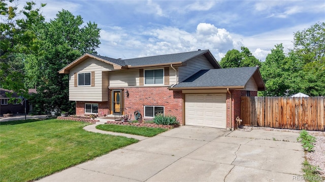 6631 Welch Ct, Arvada, CO 80004 - raised ranch with brick siding, an attached garage, concrete driveway, and a shingled roof