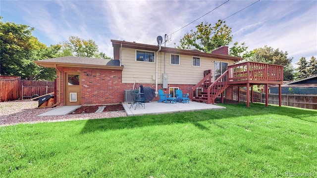 6631 Welch Ct, Arvada, CO 80004 - back of property featuring a deck, a patio, brick siding, and stairs