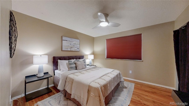 6631 Welch Ct, Arvada, CO 80004 - bedroom with wood finished floors, baseboards, a ceiling fan, and a textured ceiling