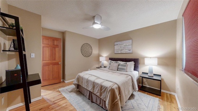 6631 Welch Ct, Arvada, CO 80004 - bedroom with wood finished floors, baseboards, a textured ceiling, and ceiling fan