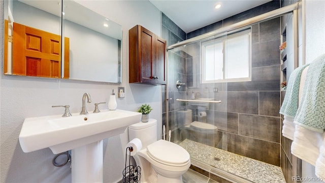 6631 Welch Ct, Arvada, CO 80004 - bathroom featuring toilet, a stall shower, and recessed lighting