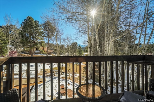 view of snow covered back of property