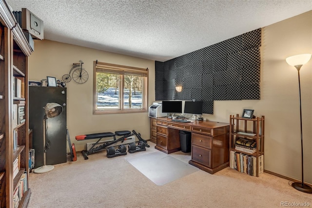 carpeted office space with a textured ceiling