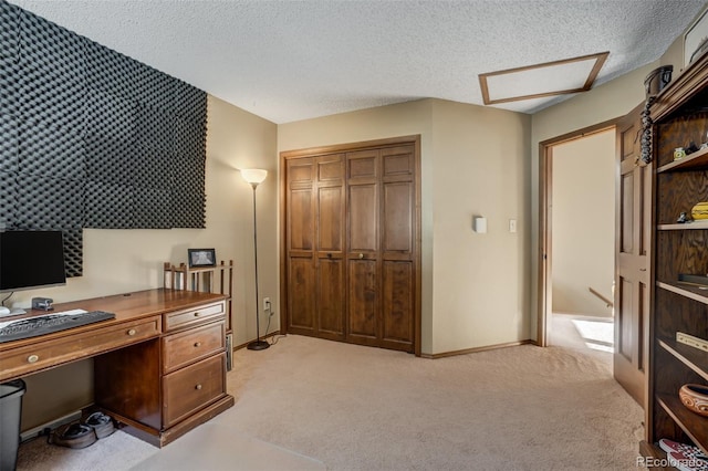 carpeted office space with a textured ceiling