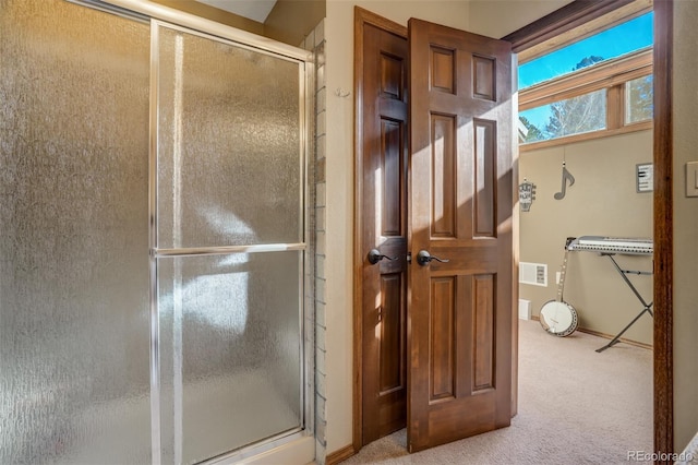 bathroom with a shower with shower door