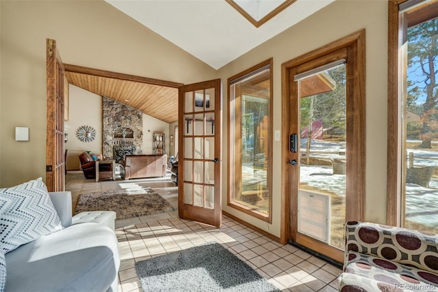 320 Morning Sun Dr, Woodland Park, CO 80863 - doorway to outside with lofted ceiling, light tile patterned flooring, wooden ceiling, and a stone fireplace
