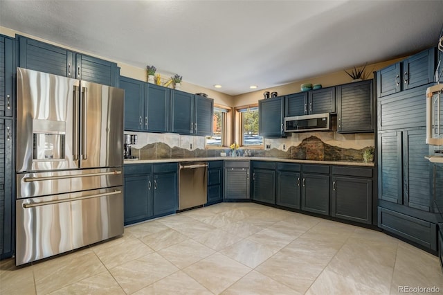 320 Morning Sun Dr, Woodland Park, CO 80863 - kitchen with appliances with stainless steel finishes, decorative backsplash, a sink, light tile patterned floors, and recessed lighting