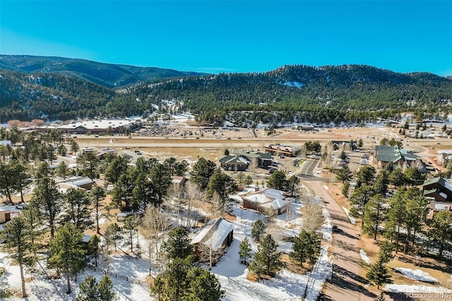320 Morning Sun Dr, Woodland Park, CO 80863 - aerial overview of property's location with a mountain backdrop and nearby suburban area