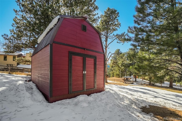 320 Morning Sun Dr, Woodland Park, CO 80863 - snow covered structure featuring an outbuilding, fence, and a storage unit