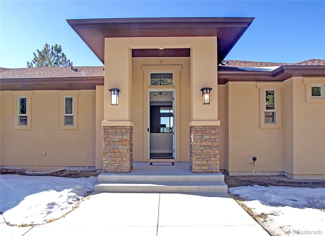 view of snow covered property entrance