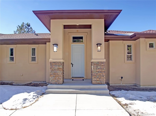 view of snow covered property entrance