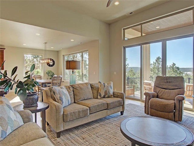 living room featuring an inviting chandelier and a healthy amount of sunlight