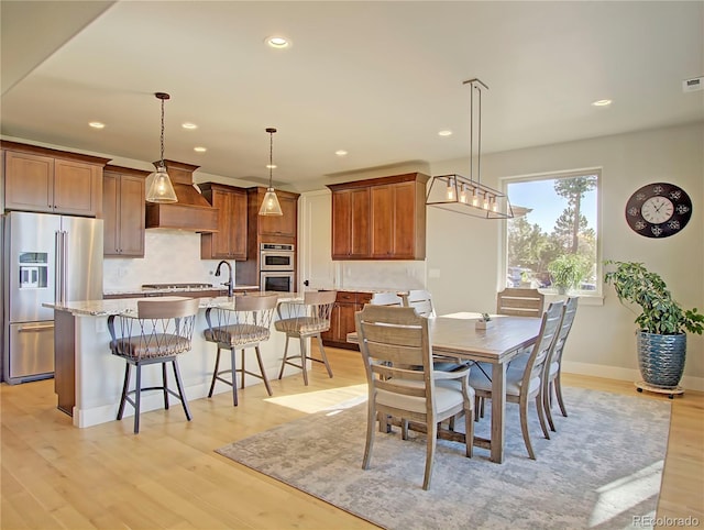 dining area with light hardwood / wood-style flooring