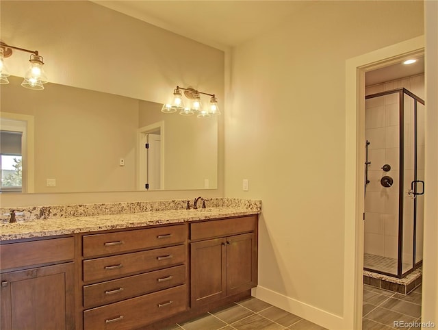 bathroom featuring vanity, tile patterned flooring, and walk in shower