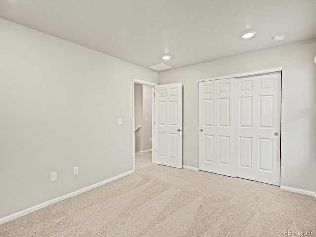 unfurnished bedroom featuring a closet, carpet flooring, and baseboards