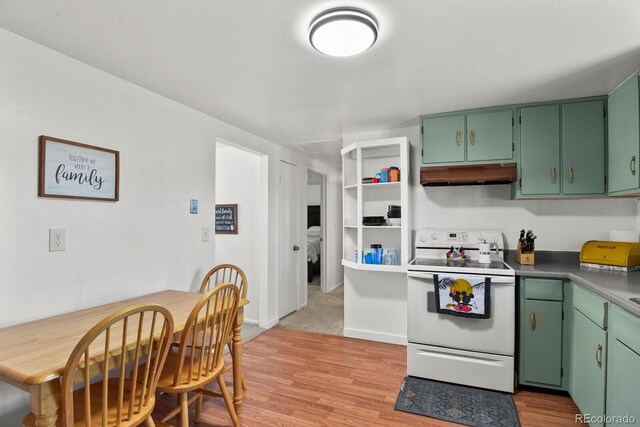 kitchen with electric stove, light hardwood / wood-style flooring, and green cabinetry