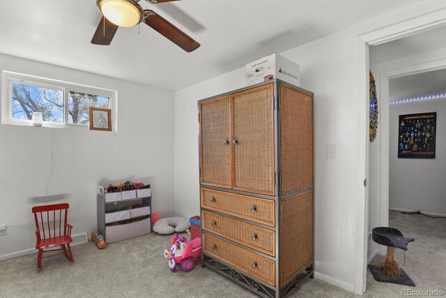 interior space with light carpet and ceiling fan