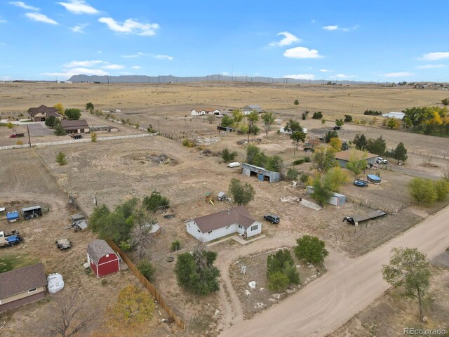 birds eye view of property with a rural view