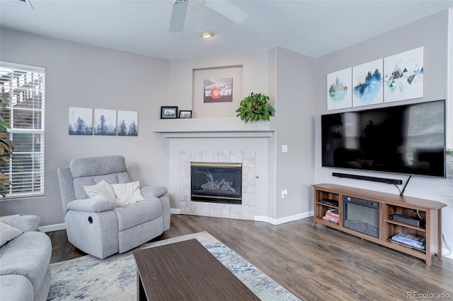 3993 S Dillon Way Unit 104, Aurora, CO 80014 - living room with wood finished floors, baseboards, a tiled fireplace, and ceiling fan