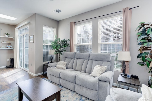 3993 S Dillon Way Unit 104, Aurora, CO 80014 - living room featuring wood finished floors and baseboards
