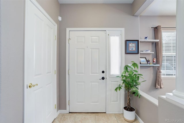 3993 S Dillon Way Unit 104, Aurora, CO 80014 - entryway with plenty of natural light, light tile patterned floors, and baseboards