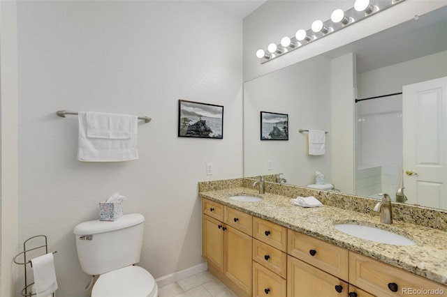 3993 S Dillon Way Unit 104, Aurora, CO 80014 - bathroom with toilet, double vanity, tile patterned floors, a shower, and baseboards