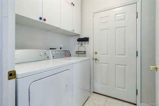 3993 S Dillon Way Unit 104, Aurora, CO 80014 - clothes washing area featuring cabinet space, washing machine and dryer, and light tile patterned flooring