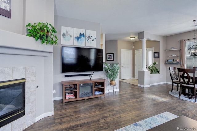 3993 S Dillon Way Unit 104, Aurora, CO 80014 - living area featuring ornate columns, baseboards, wood finished floors, and a fireplace