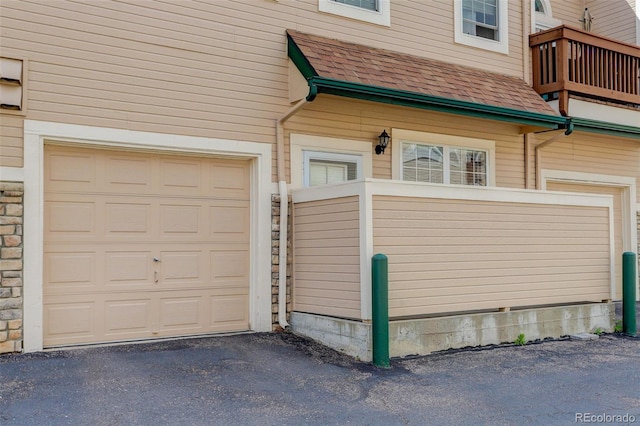 3993 S Dillon Way Unit 104, Aurora, CO 80014 - garage featuring asphalt driveway