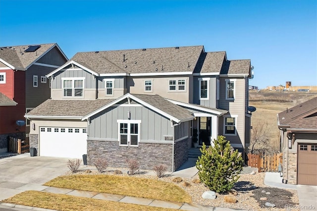 view of front of property featuring concrete driveway, board and batten siding, and roof with shingles