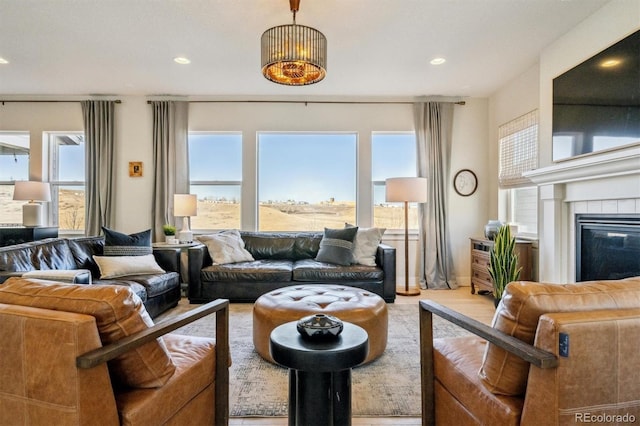 living room featuring a fireplace, wood finished floors, and recessed lighting