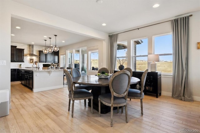 dining area featuring light wood-style flooring, a wealth of natural light, and recessed lighting