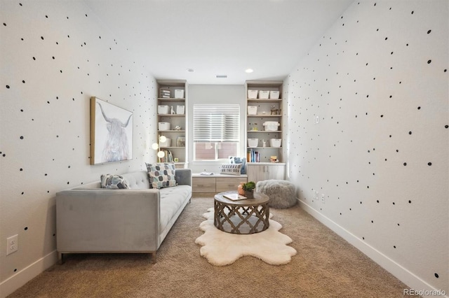 sitting room with carpet, visible vents, and baseboards