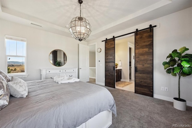 carpeted bedroom featuring a raised ceiling, visible vents, an inviting chandelier, a barn door, and baseboards