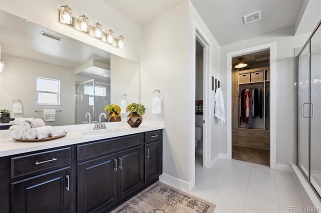 bathroom with a shower stall, visible vents, and tile patterned floors