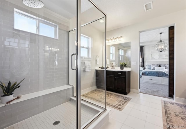 full bath with connected bathroom, vanity, visible vents, a shower stall, and tile patterned floors