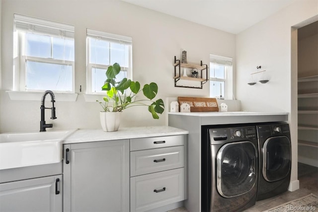 laundry area with a sink and washing machine and clothes dryer