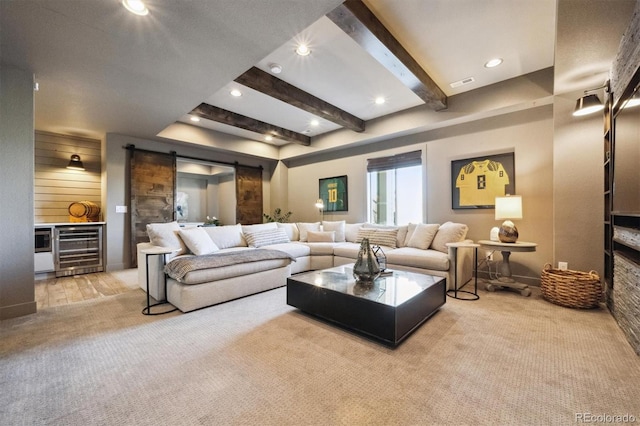 living area featuring beam ceiling, visible vents, a barn door, carpet flooring, and beverage cooler