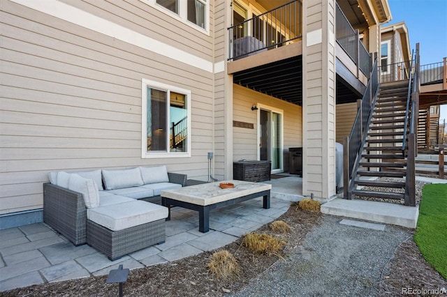 view of patio / terrace featuring stairs and an outdoor living space