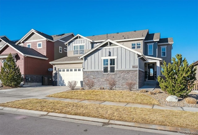 craftsman-style house featuring an attached garage, stone siding, board and batten siding, and concrete driveway