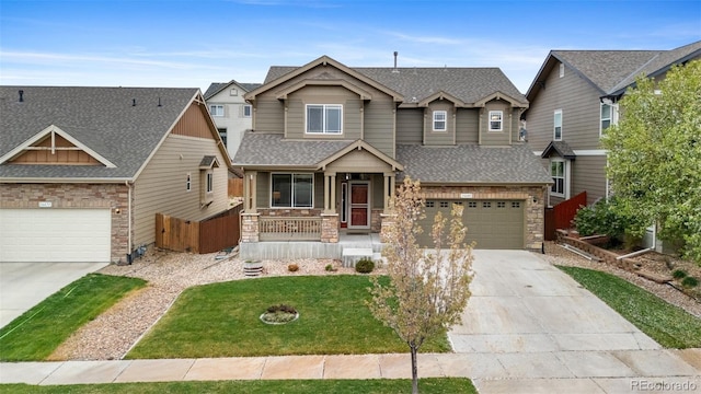 16685 E 101st Ave, Commerce City, CO 80022 - craftsman inspired home featuring a front yard, stone siding, a shingled roof, concrete driveway, and a porch